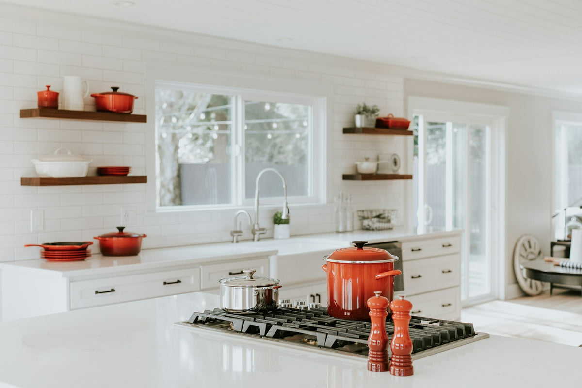 Pepper mill beside cooking pots in a calm, tidy kitchen
