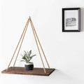 Boho macrame hanging shelf on a wall